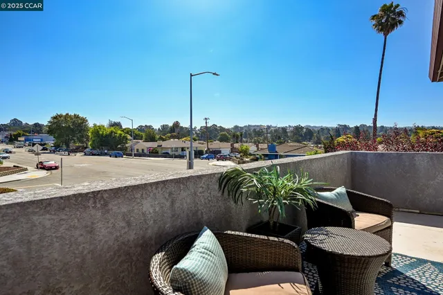 a view of a balcony with furniture