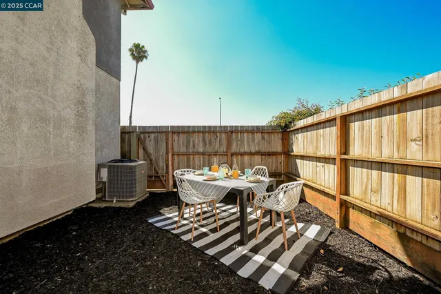 a roof deck with wooden floor and outdoor seating