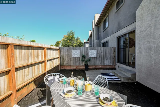 a backyard of a house with table and chairs