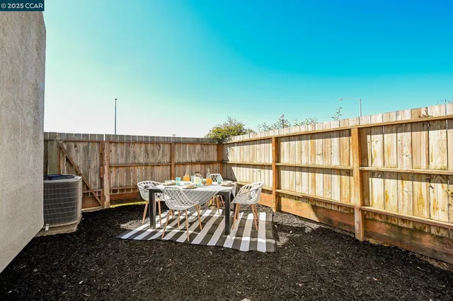a view of a patio with a table and chairs