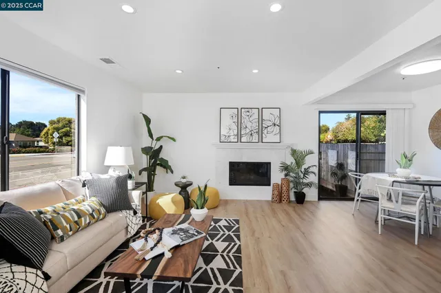 a living room with furniture a fireplace and a table