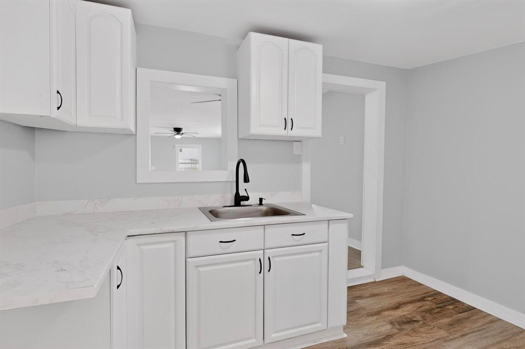 313 Farm To Market 316 Eustace, TX 75124 - Photo 13 of 33 a kitchen with white cabinets and sink