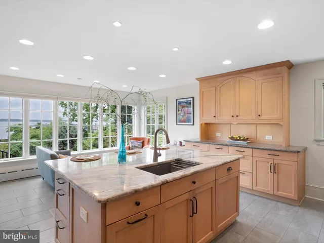 a kitchen with center island and windows