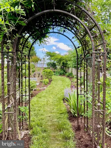 a view of a backyard with table and chairs and potted plants