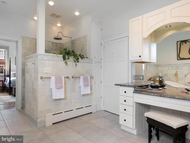 a bedroom with furniture and a window
