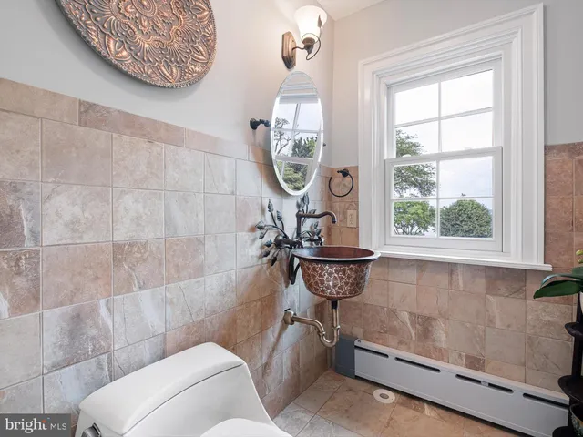 a bedroom with a bed and a wooden floor