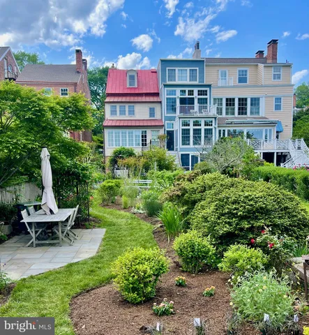 a view of a building with garden and sitting area