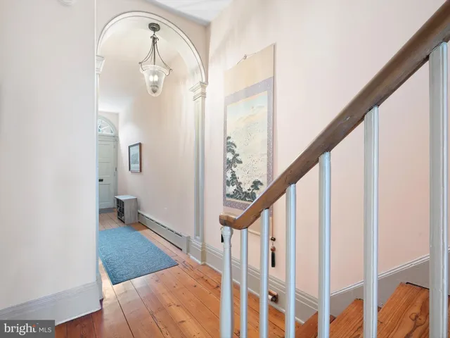 a view of staircase with railing and a chandelier