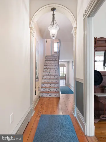 a view of a hallway view with wooden floor and staircase