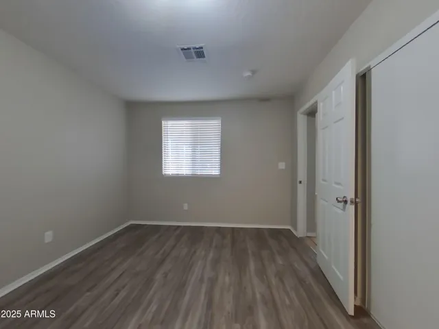 a view of a room with wooden floor and windows