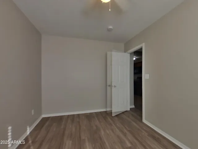a view of an empty room and wooden floor