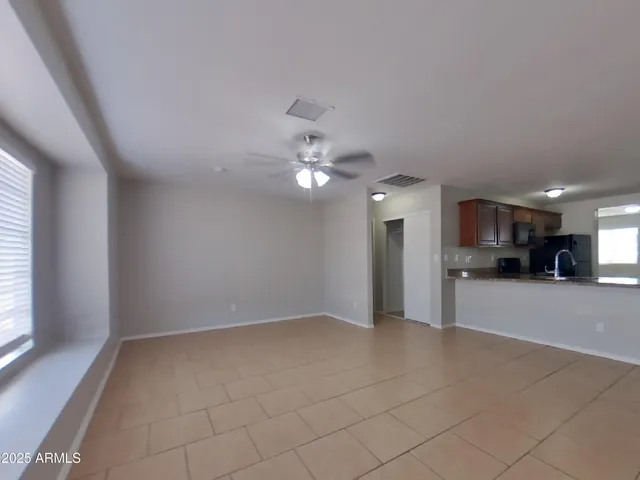 a view of a kitchen with a sink and a large window