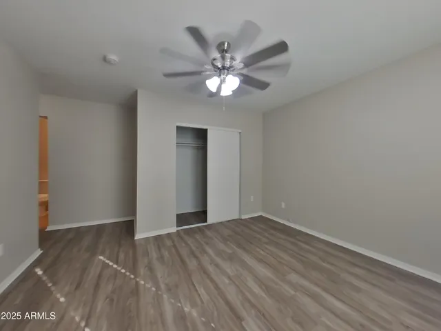 a view of an empty room with wooden floor