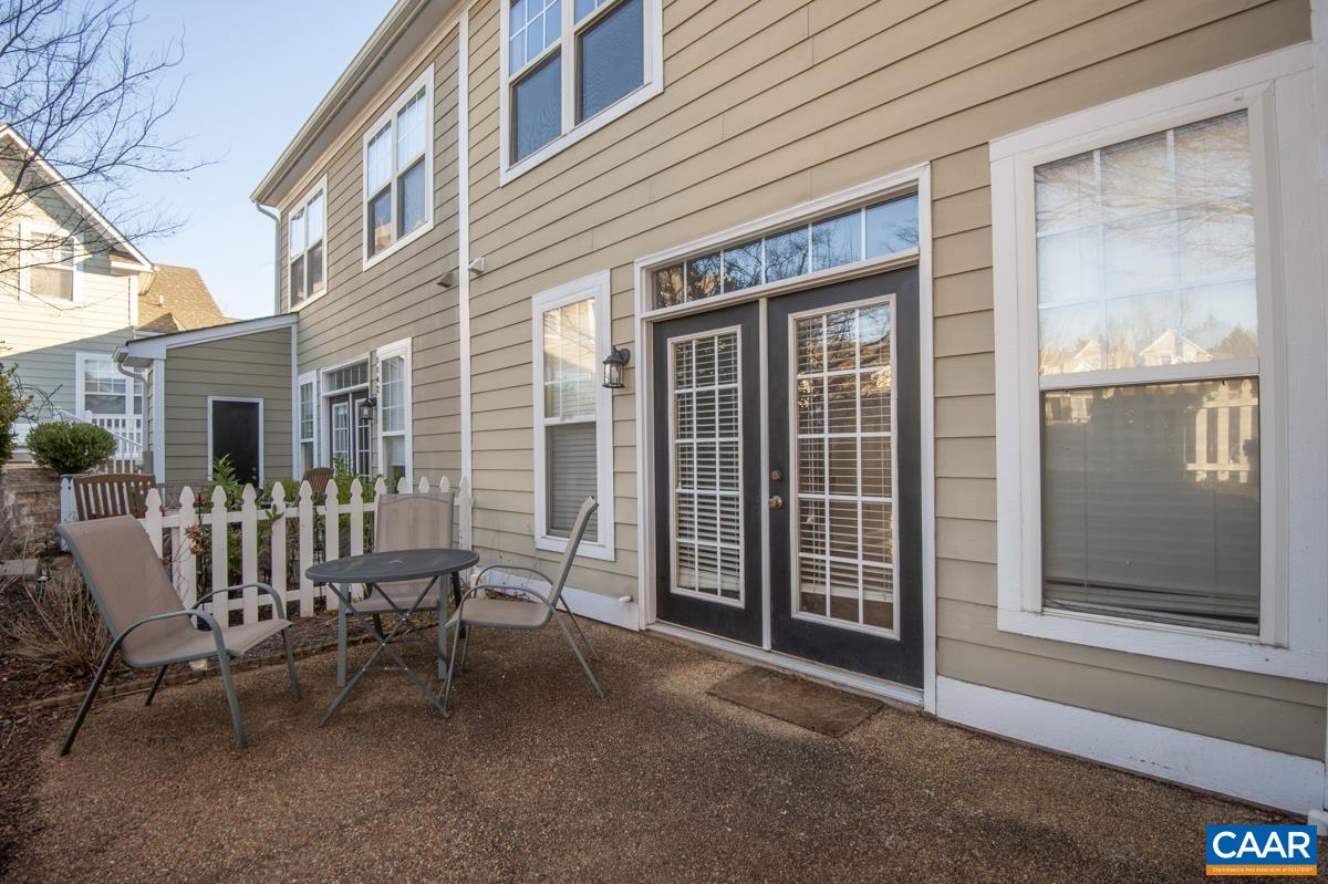 1140 Edmond Court Crozet, VA 22932 - Photo 13 of 34 a view of a patio with a table and chairs and floor to ceiling window