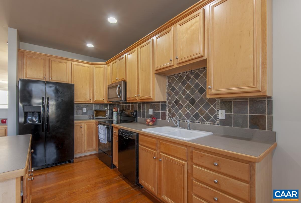1140 Edmond Court Crozet, VA 22932 - Photo 14 of 34 a kitchen with a sink a refrigerator and cabinets