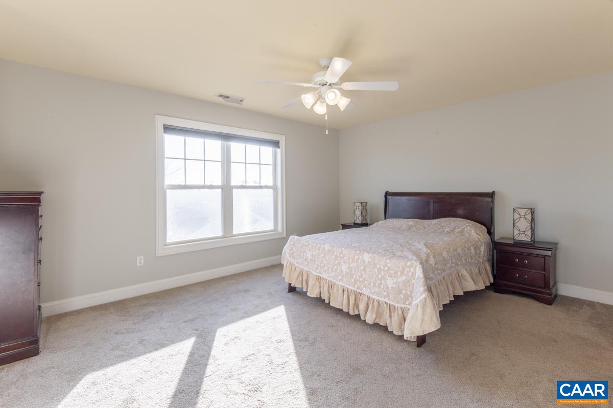1140 Edmond Court Crozet, VA 22932 - Photo 19 of 34 a spacious bedroom with a bed and a window