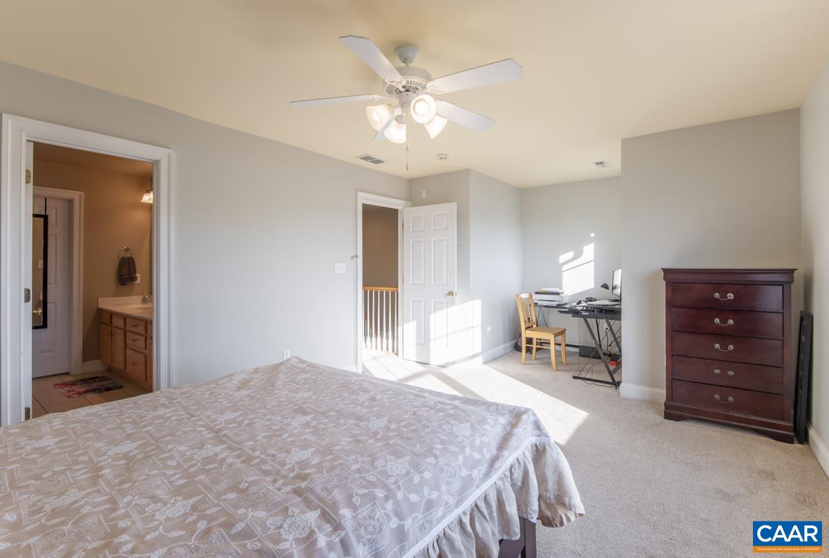 1140 Edmond Court Crozet, VA 22932 - Photo 20 of 34 a bedroom with a bed and a chandelier