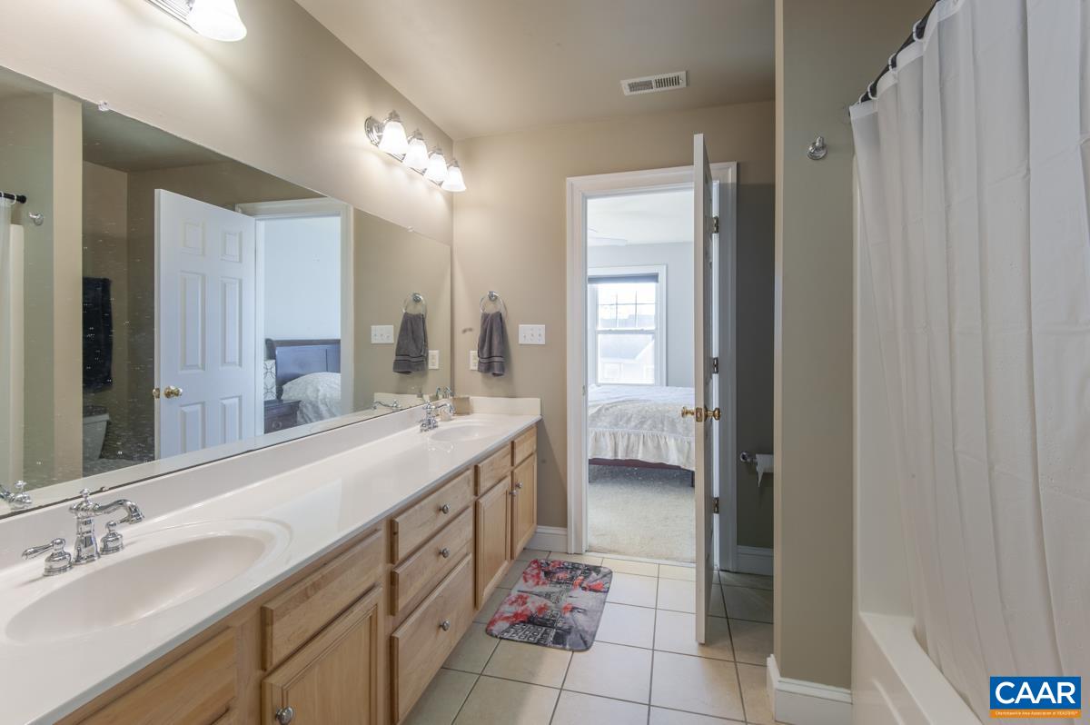 1140 Edmond Court Crozet, VA 22932 - Photo 22 of 34 a bathroom with a double vanity sink a mirror and a