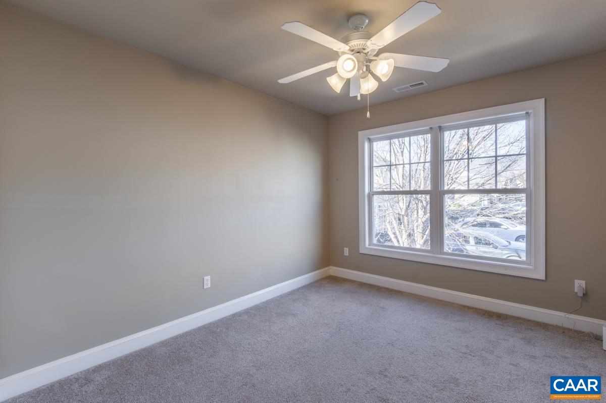 1140 Edmond Court Crozet, VA 22932 - Photo 23 of 34 an empty room with windows and chandelier fan