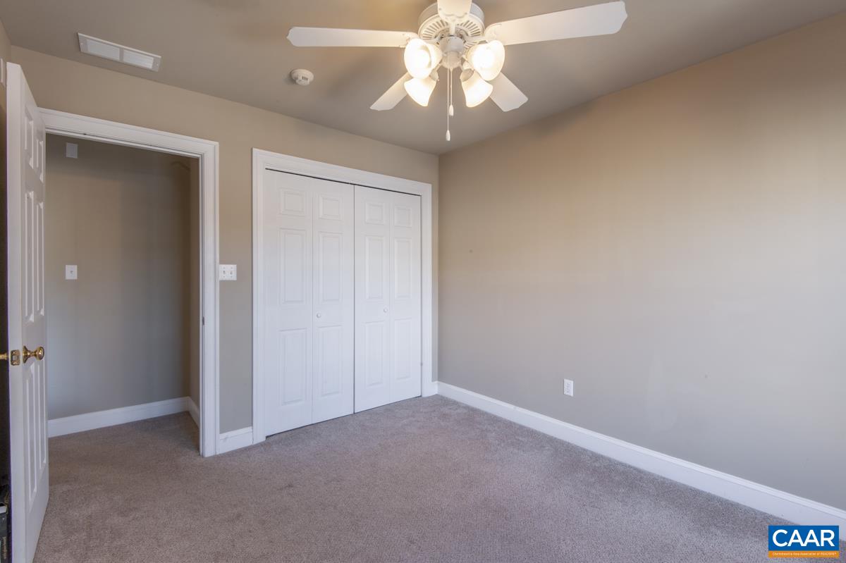 1140 Edmond Court Crozet, VA 22932 - Photo 24 of 34 an empty room with a chandelier fan and windows