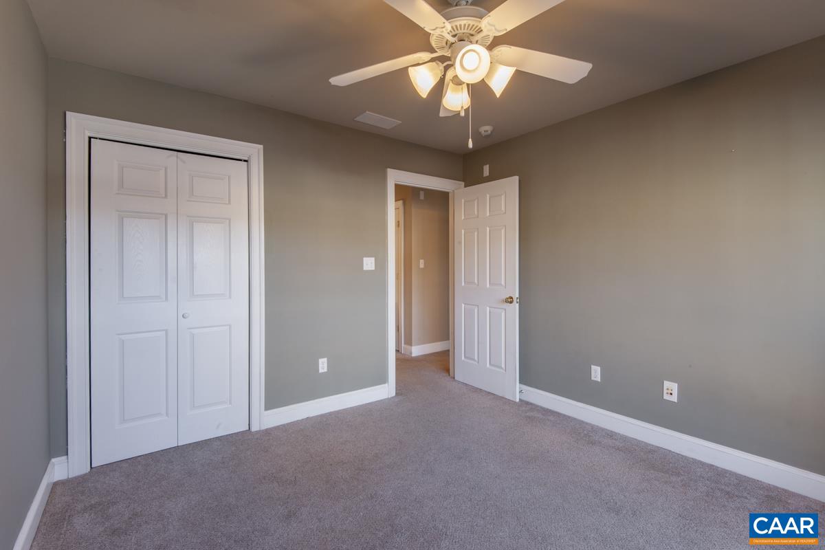 1140 Edmond Court Crozet, VA 22932 - Photo 26 of 34 an empty room with a chandelier fan and a ceiling fan