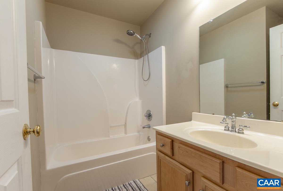 1140 Edmond Court Crozet, VA 22932 - Photo 27 of 34 a bathroom with a granite countertop sink mirror bathtub and shower