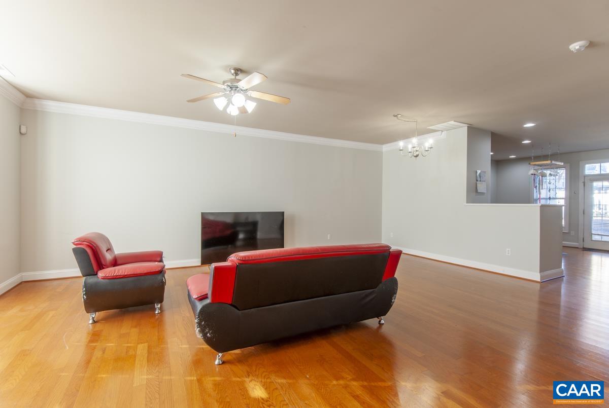 1140 Edmond Court Crozet, VA 22932 - Photo 5 of 34 a living room with furniture a ceiling fan and a rug