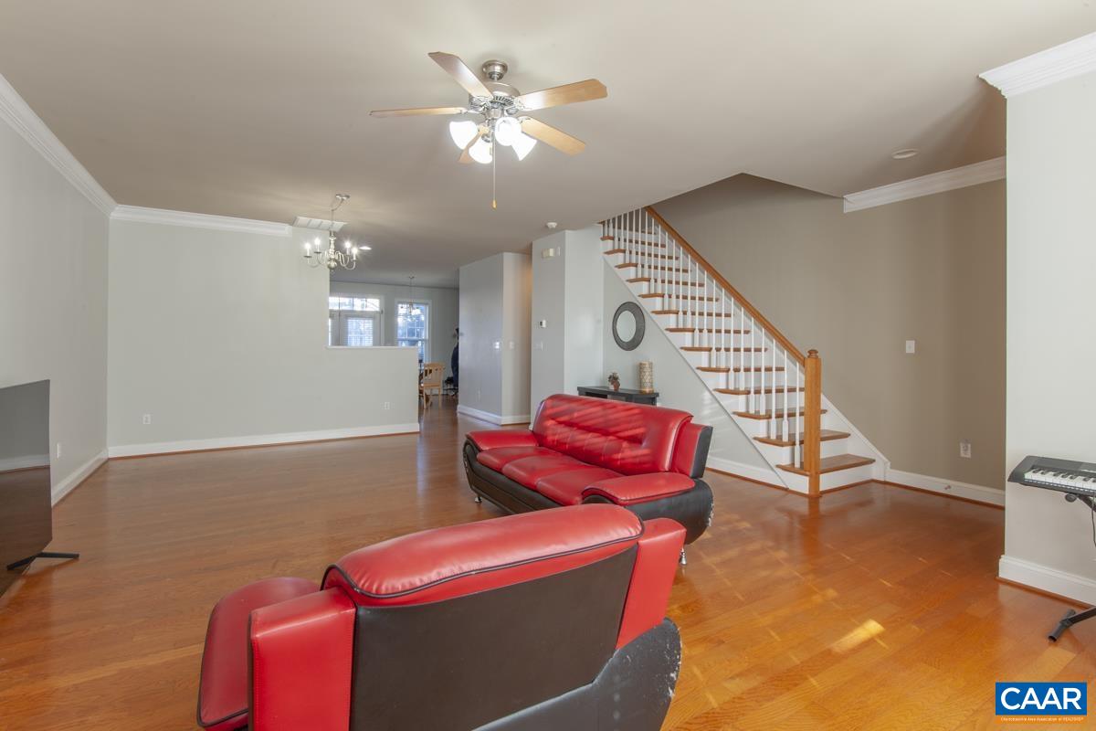 1140 Edmond Court Crozet, VA 22932 - Photo 6 of 34 a living room with furniture a ceiling fan and a rug