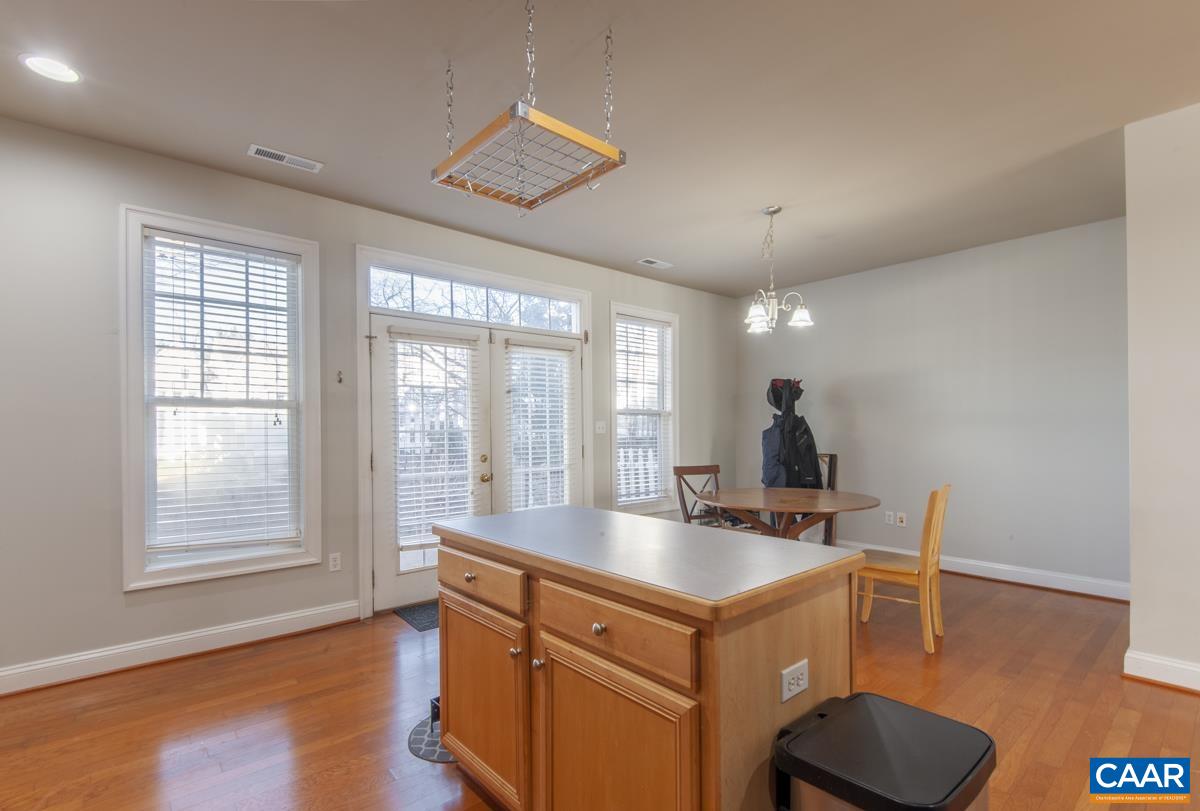 1140 Edmond Court Crozet, VA 22932 - Photo 10 of 34 a kitchen that has a sink and a large window with wooden floor