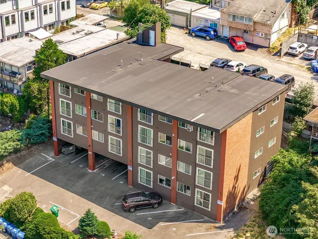 an aerial view of multiple houses with a yard