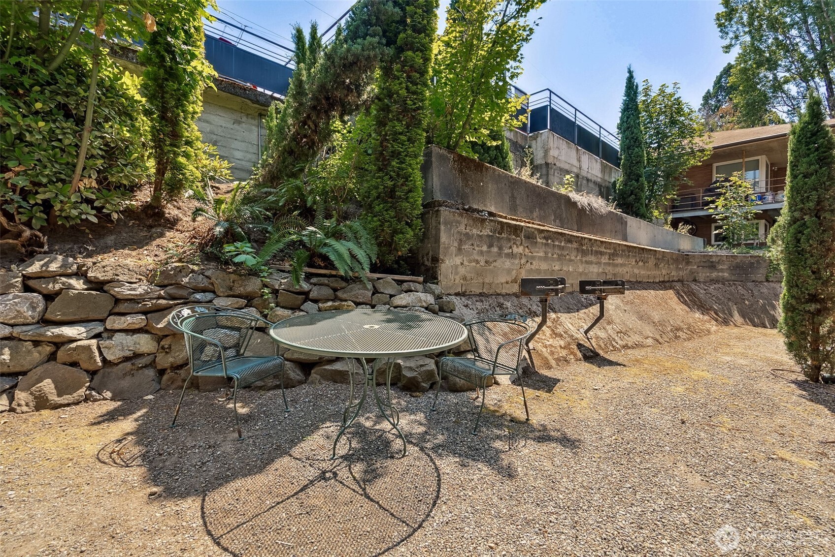 2414 13th Avenue South Seattle, WA 98144 - Photo 17 of 17 a view of a backyard with table and chairs with wooden fence and plants