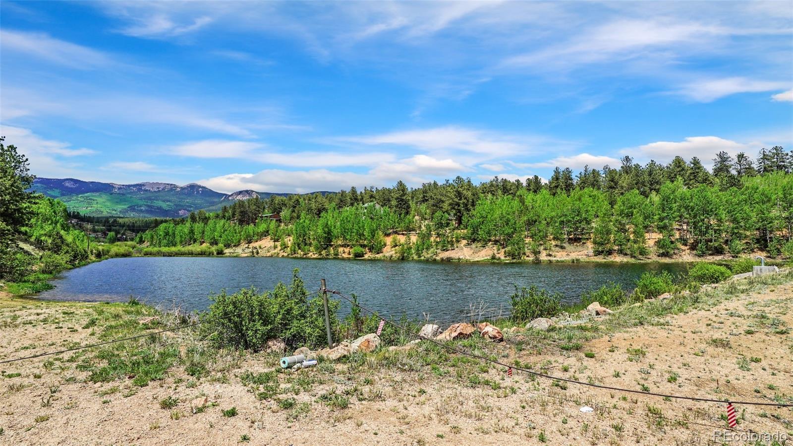 109 Wolf Road Bailey, CO 80421 - Photo 14 of 18 a view of a lake with a mountain in the background