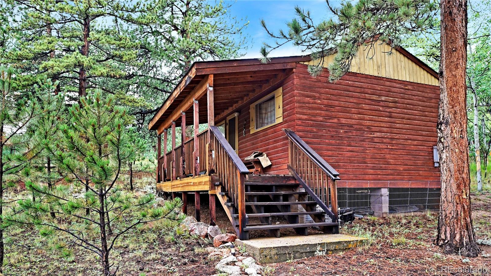 109 Wolf Road Bailey, CO 80421 - Photo 2 of 18 a front view of a house with a tree