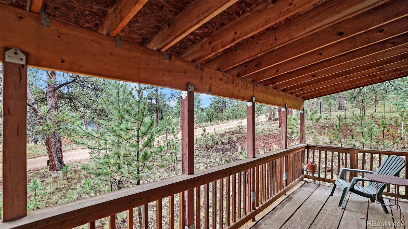 109 Wolf Road Bailey, CO 80421 - Photo 3 of 18 a view of a balcony with wooden floor