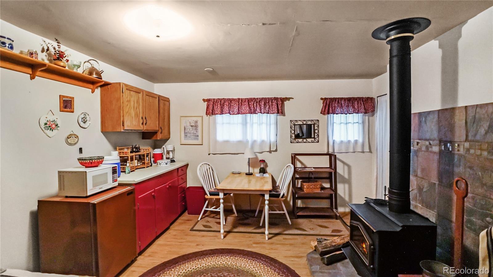 109 Wolf Road Bailey, CO 80421 - Photo 4 of 18 a dining room with furniture and a flat screen tv