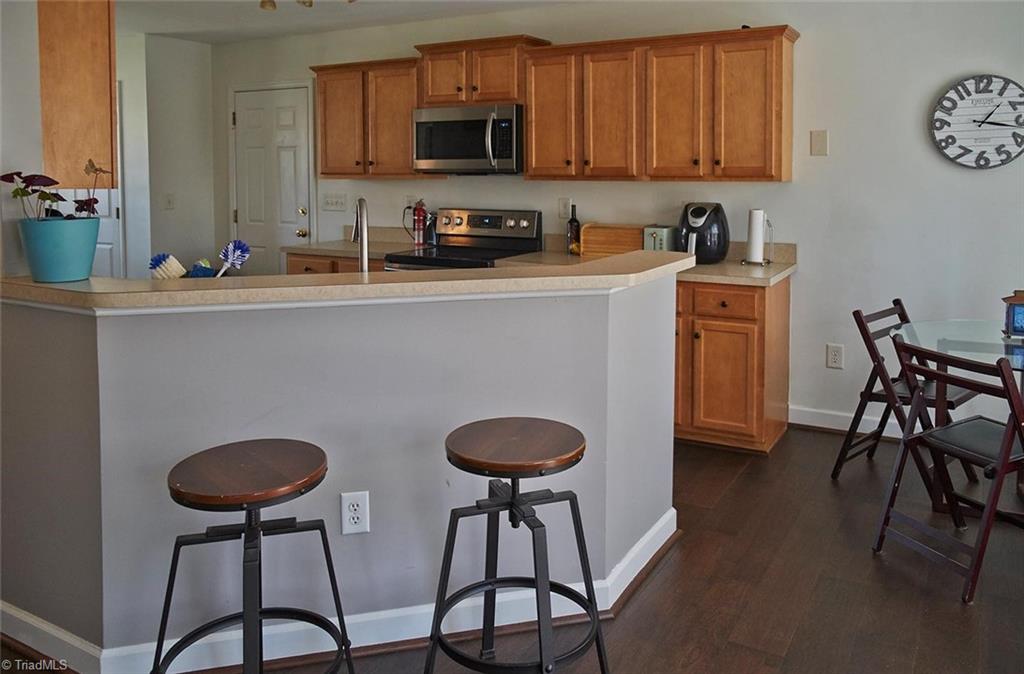 8117 Chestershire Road Oak Ridge, NC 27310 - Photo 16 of 50 There's room for bar stools at the kitchen penninsula.