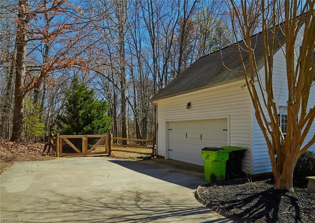 8117 Chestershire Road Oak Ridge, NC 27310 - Photo 4 of 50 Side load double garage, and fenced yard.