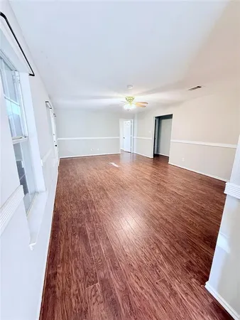 a view of an empty room and wooden floor