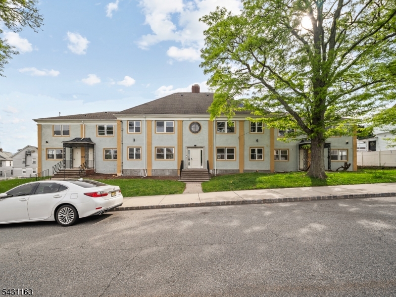 100 Chestnut Street, Unit 3 West Orange, NJ 07052 - Photo 1 of 18 a car parked in front of white house with a yard