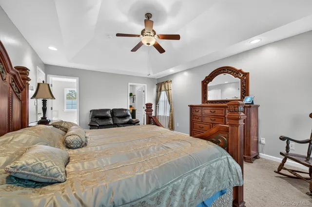 a bedroom with a large bed and a chandelier