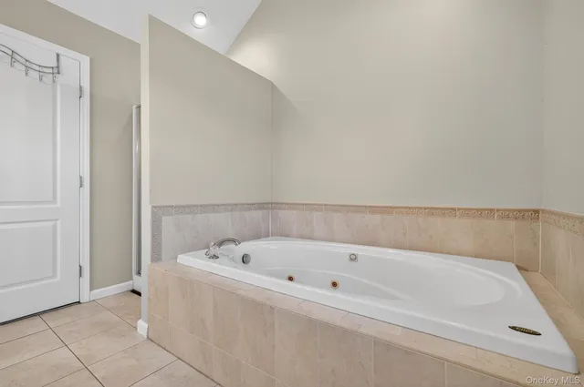 a white bath tub sitting in a bathroom