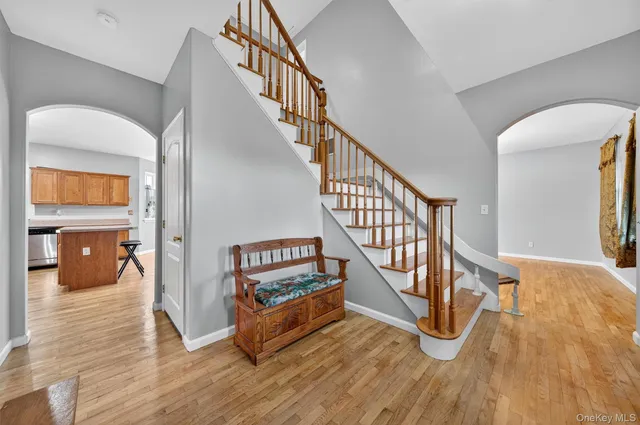 a view of entryway and hall with wooden floor