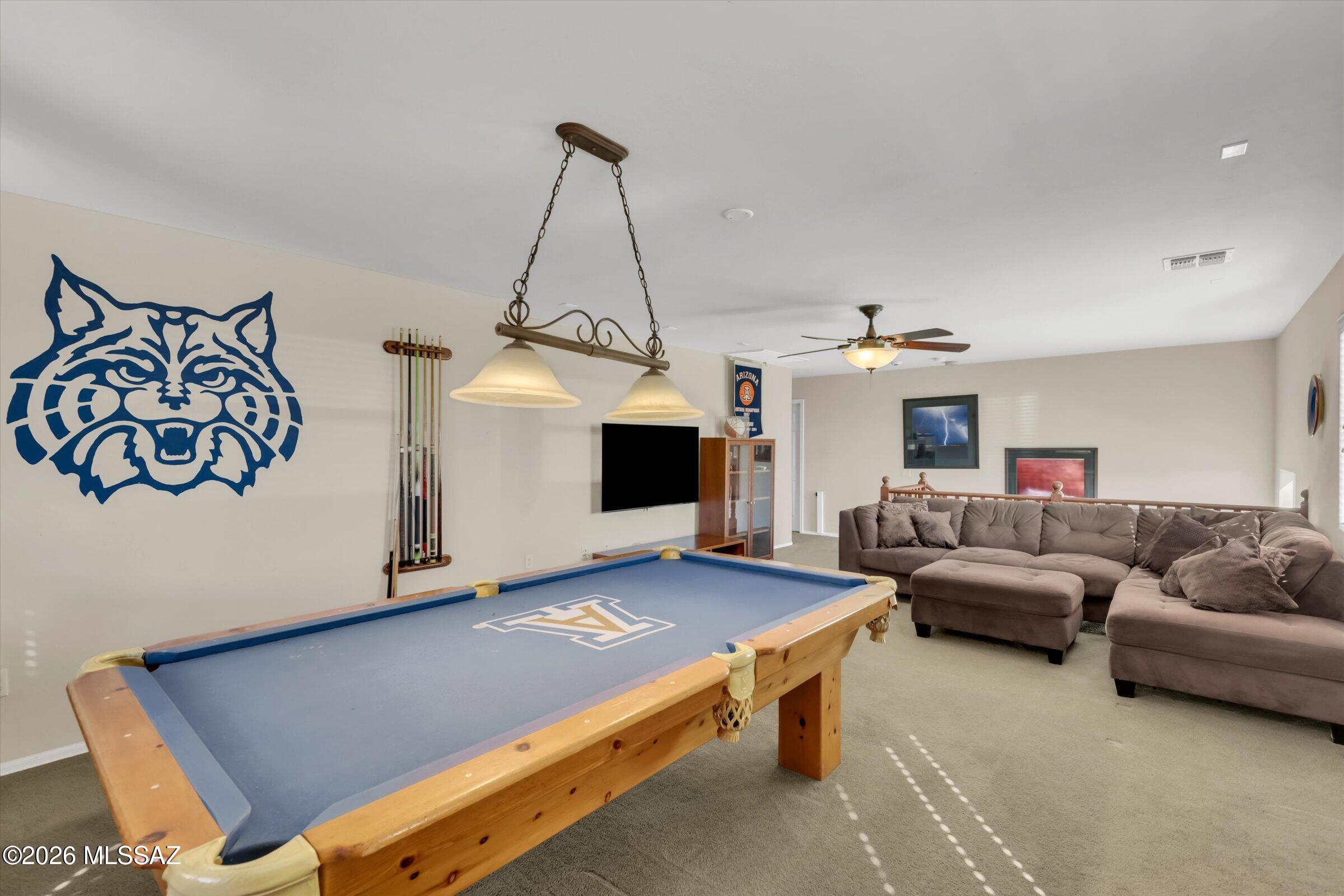 6095 South Jakemp Trail Tucson, AZ 85747 - Photo 2 of 52 a living room with furniture and a chandelier