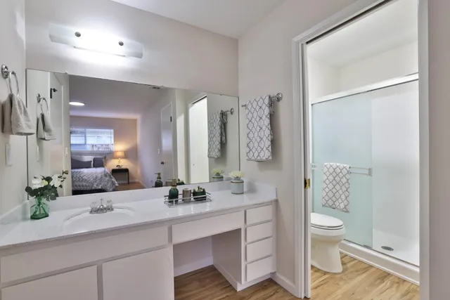 a bathroom with a double vanity sink toilet and shower