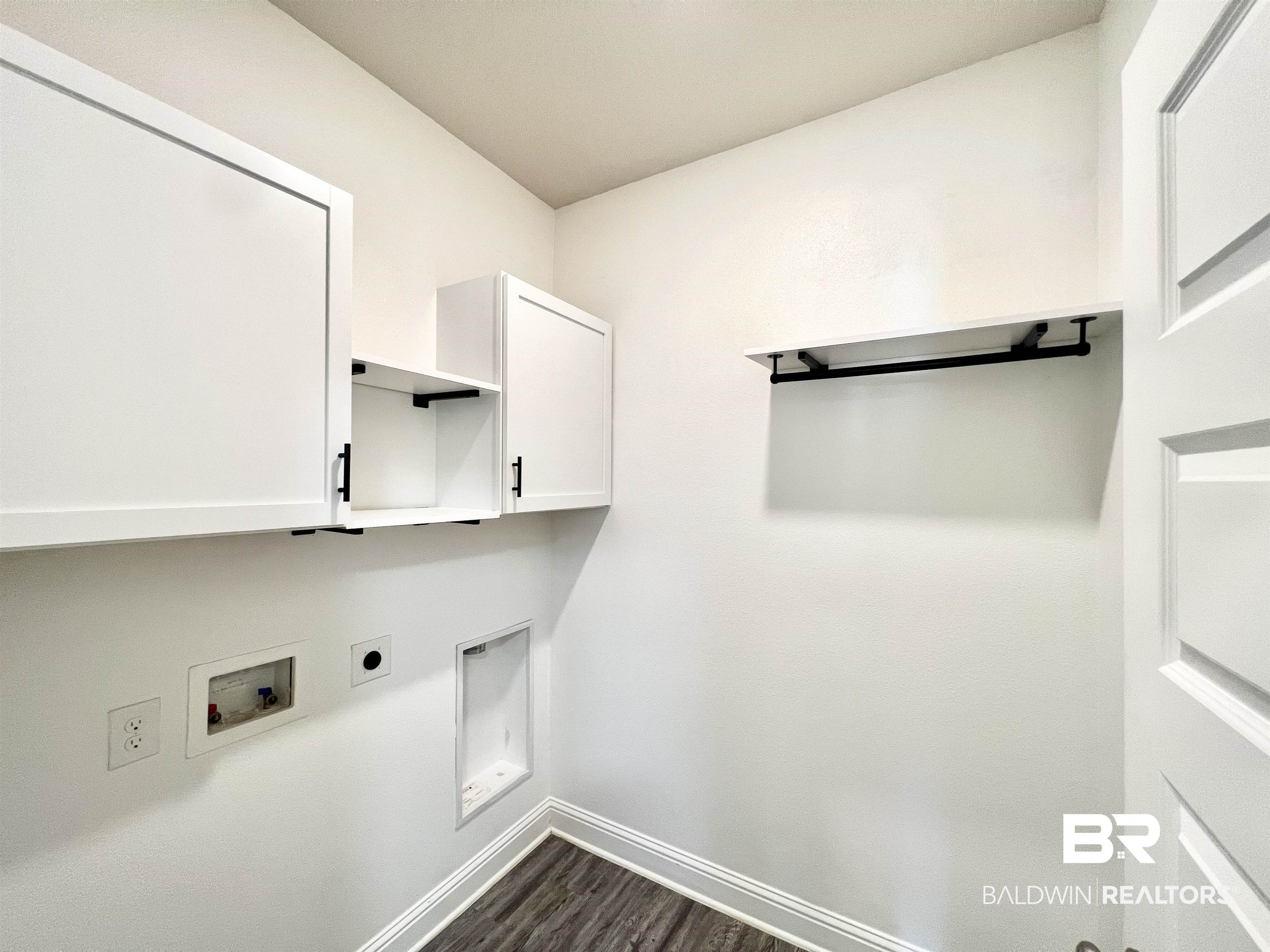 24785 Slater Mill Road Daphne, AL 36526 - Photo 21 of 46 Clothes washing area featuring cabinets, hookup for an electric dryer, washer hookup, and dark hardwood / wood-style flooring