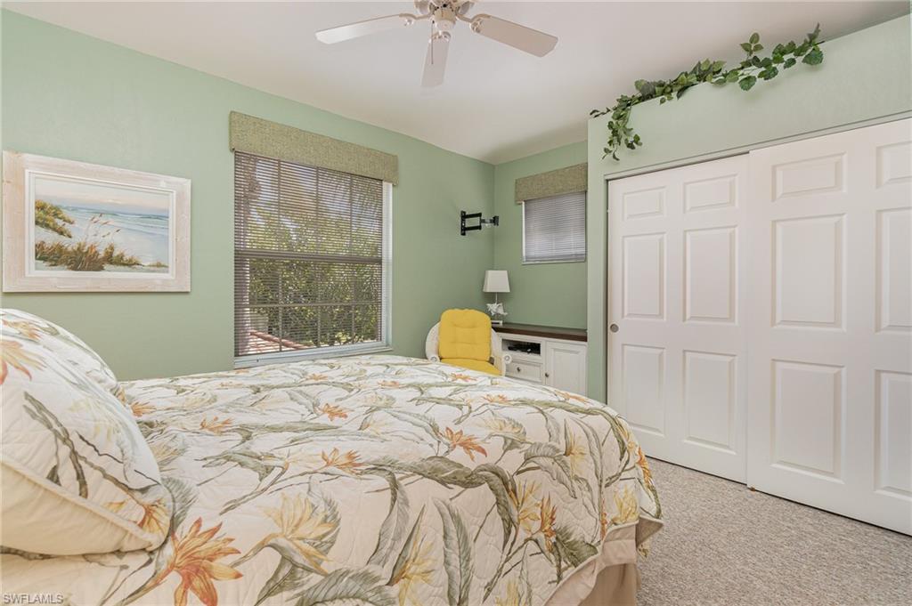 10921 Oak Island Road, Unit 203 Estero, FL 34135 - Photo 19 of 25 a bedroom with a bed and a chandelier