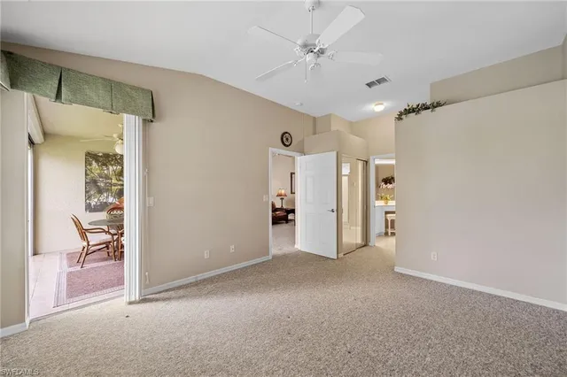 a view of empty room with a fan