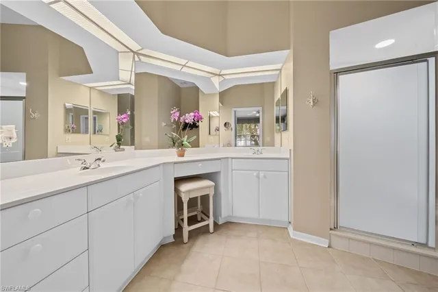 a spacious bathroom with a double vanity sink mirror and