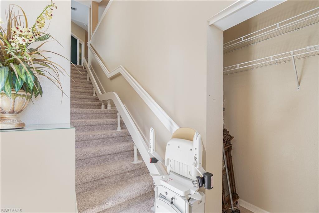 10921 Oak Island Road, Unit 203 Estero, FL 34135 - Photo 5 of 25 a view of entryway with wooden floor and stairs