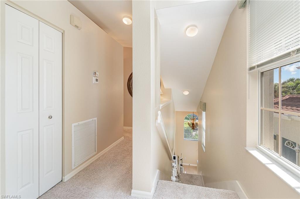 10921 Oak Island Road, Unit 203 Estero, FL 34135 - Photo 6 of 25 a view of a hallway with a livingroom and a bathroom with a sink